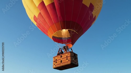 Hot Air Balloon Ascending Against Clear Blue Sky  