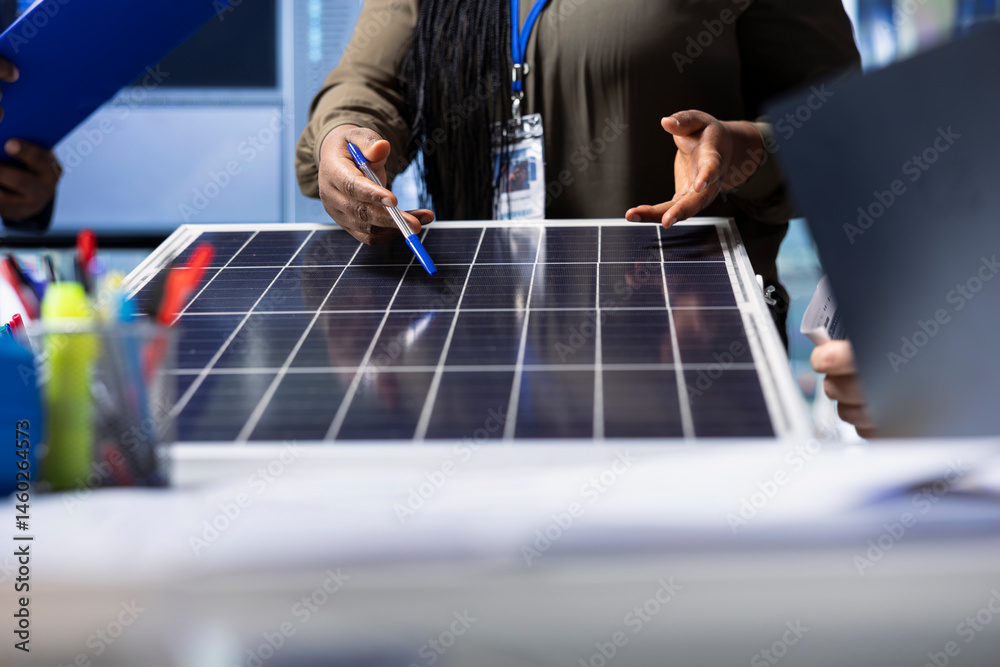 Photovoltaics factory expert reviewing solar panel design, discussing technical specifications and performance details during collaborative meeting focused on sustainable energy solutions, close up