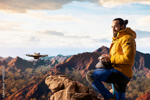 Obraz na płótnie Content creator enjoying the fresh air and filming with his drone, recording professional video on mountain range valley aerial view. Influencer filming his latest travel vlog. w salonie