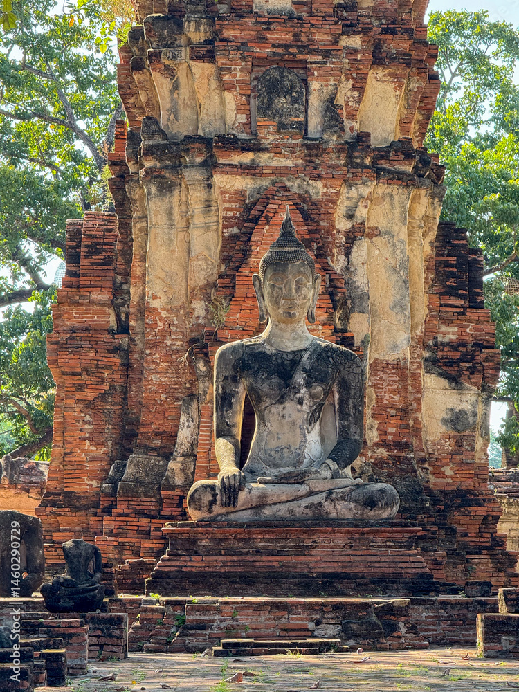 Ancient Buddha statues sitting peacefully in a sacred temple complex, Wat Maha That landmark representing faith and spirituality. Beautiful culture religious destination in Thailand.