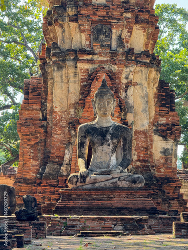 Ancient Buddha statues sitting peacefully in a sacred temple complex, Wat Maha That landmark representing faith and spirituality. Beautiful culture religious destination in Thailand.