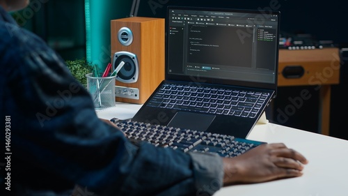 Teleworker in living room office using laptop to do coding for software developing, handheld camera shot. Remote employee typing on device keyboard, solving tasks in apartment, camera A close up