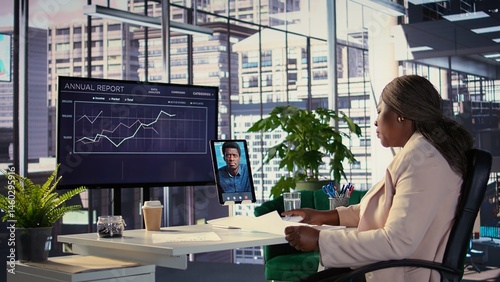 Black business entrepreneur pitching a new project idea to a shareholder via videocall, discussing about investing more funds for global expansion. Female CEO with determination for growth. Camera B.