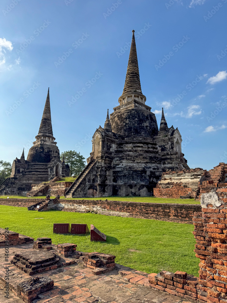 Wat Chaiwatthanaram Ayutthaya temple seen from river boat, ancient famous brick towers under a golden sunset. Traditional heritage, culture. Amazing majestic religious structure.