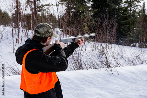 Young man hunting small game on a cold winter day