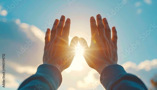 Hands framing the sun at sunset, a feeling of hope and peace.