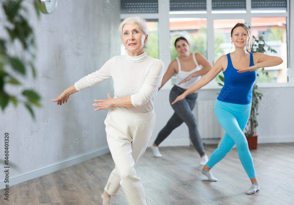Naklejka premium Positive women engaged in active dancing in the studio during a group workout
