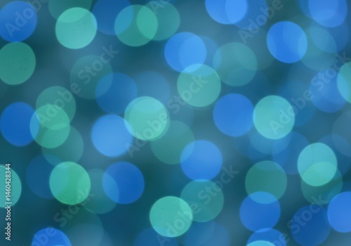 Abstract bokeh background with blurred blue and green circles, perfect for various designs.