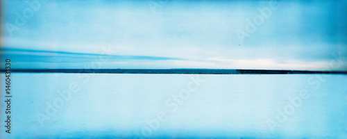 Panoramic image of Coney Island beach covered in snow in the winter