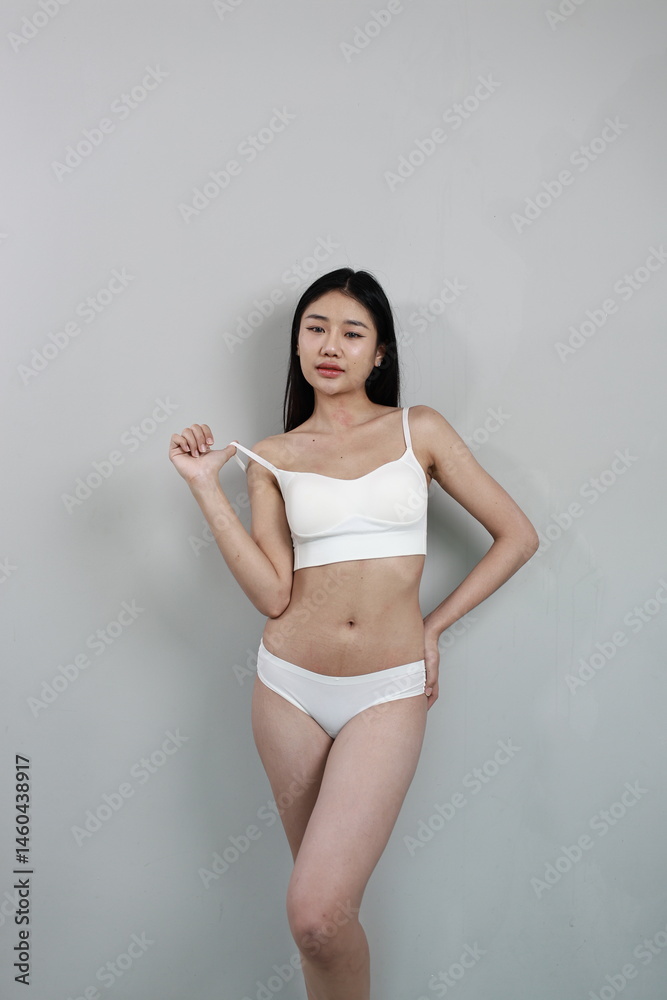Fototapeta premium A confident woman embraces her natural beauty and body shape, celebrating skincare, health, and self-love in a diverse, body-positive lifestyle.