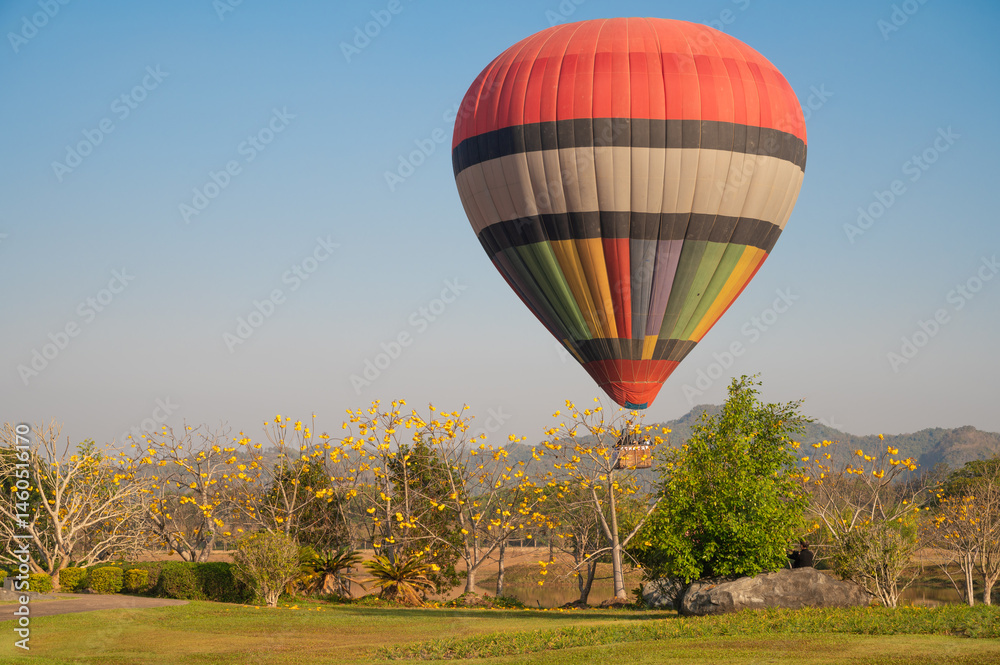 Hot air balloon prepare for landing on the field.