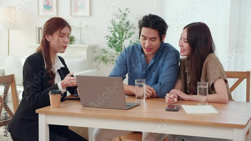 Happy asian couple discussion with real estate agent or insurance agent for investment in home office, mortgage loan or property purchase home, sale explaining insurance plan with couple.