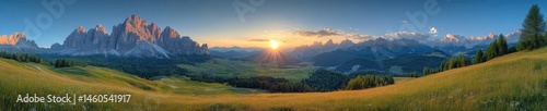 Panoramic mountain vista at sunrise over valley landscape.
