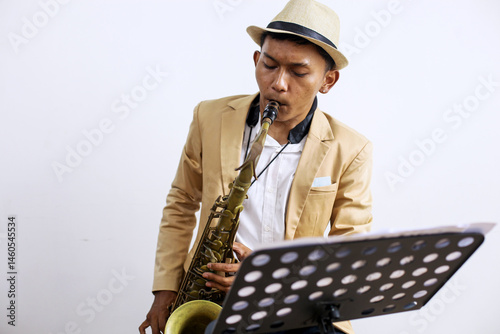 Canvas Print Portrait Of Professional Musician Male In Suit Playing On Saxophone