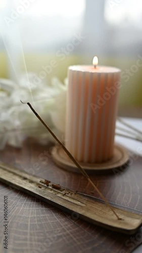Cozy spring candlelit setup with aromatic incense stick smoke and floral background, creating a serene, calming, and peaceful atmosphere