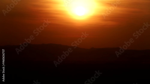 Time-lapse sunset over a mountain with colorful orange clouds, Close-up Sunset time lapse.