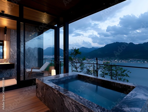 Modern, outdoor hot tub with mountain & lake views photo