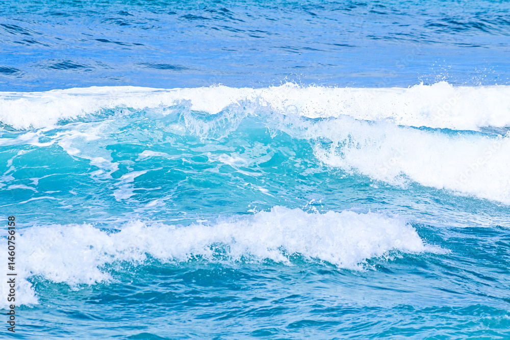 Fototapeta premium Beautiful sea waves with foam of blue and turquoise water color. Summer seascape. Travel concept and idea.