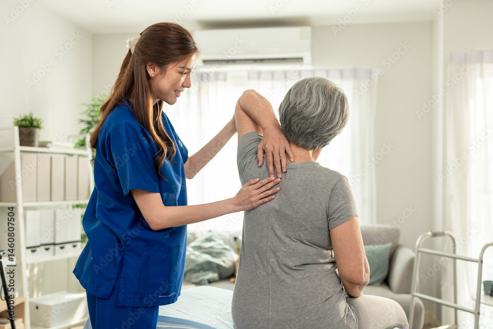 Fototapeta premium Elderly Asian woman receive physical therapy with support of caregiver. 
