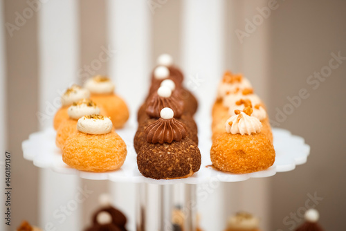 Different kinds of beautiful pastry, small colorful sweet cakes, macaron, and other dessert in the sweet buffet
