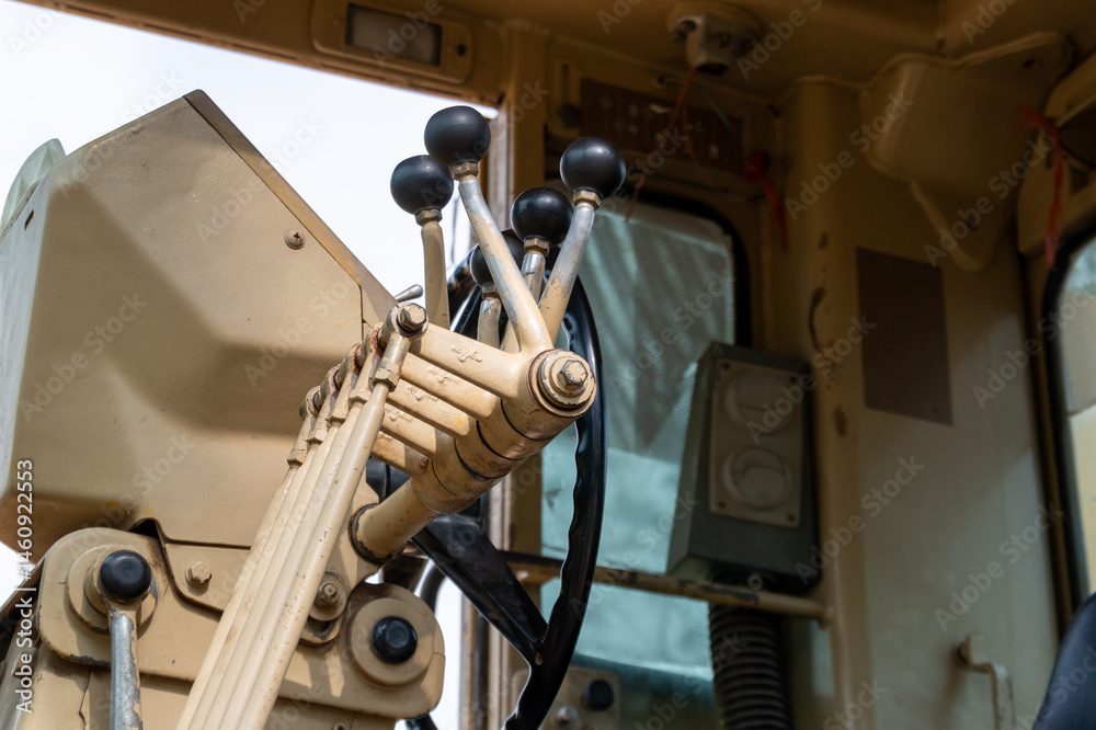 Construction equipment operators control heavy machinery at job site industrial environment close-up view