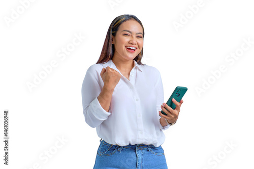 Excited young Asian woman using mobile phone gesturing yes with raised fist reacting to online news isolated on transparent background