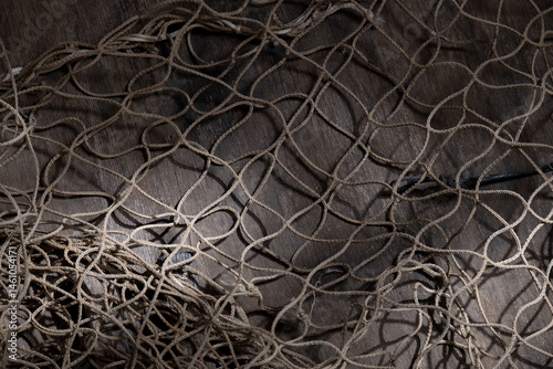 Fishing net on rustic old wood, fishing concept, art craft themes
