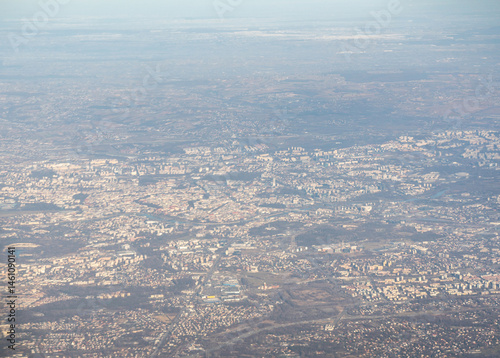Obraz na płótnie Plane window view of snow Polish fields and villages, Krakow suburbs, aircraft fly landscape w salonie