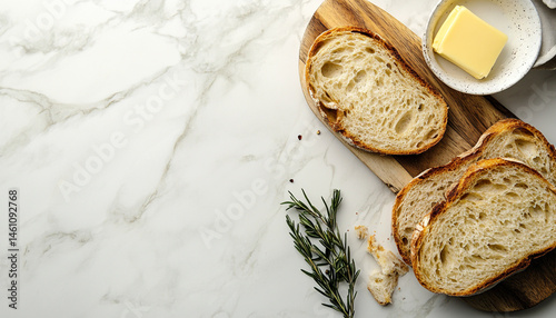 Slices of tasty bread with butter on white tile