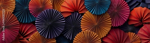 Obraz na płótnie Colorful paper fans arranged artistically on a dark background. w salonie