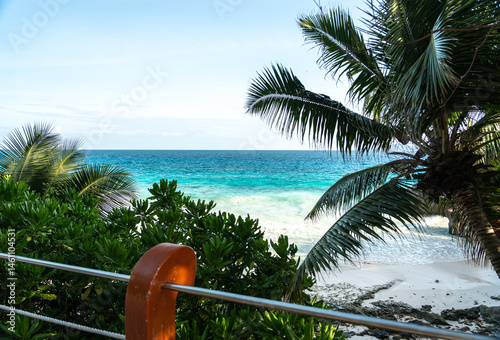 Obraz na płótnie View from the road at Anse Patates showing tropical palms, white beach, ocean waves w salonie