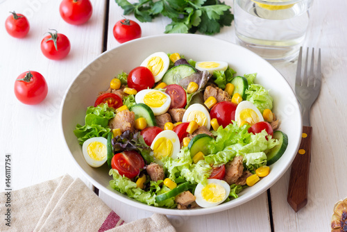 Salad with tuna, eggs, tomatoes, cucumbers and corn. Healthy eating. Diet.