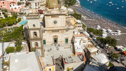 Aerial view of the collegiate church of Positano in the province of Salerno, Campania, Italy. This church is dedicated to Santa Maria Assunta and is near the beach, overlooking the Mediterranean Sea.