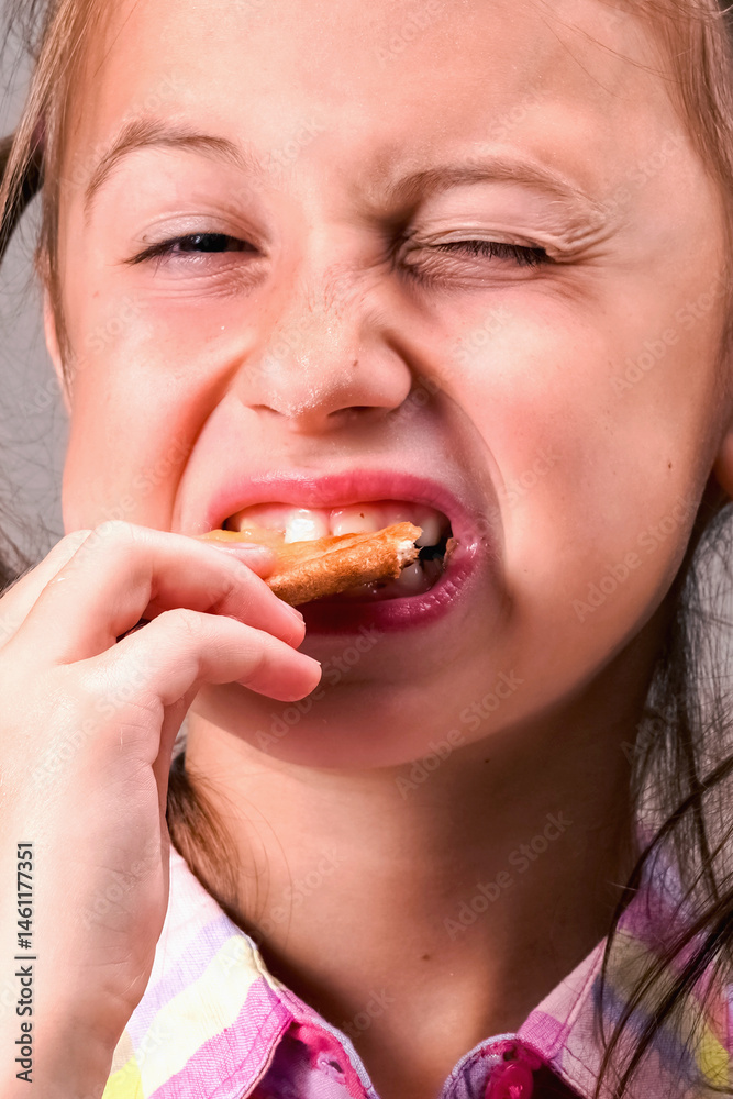 Funny portrait of young girl eating piece of pizza.