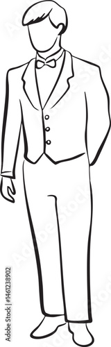A young man stands formally dressed in a suit.
