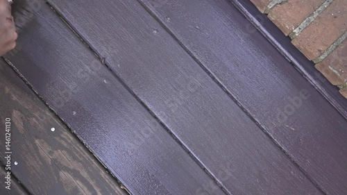 Hand With Brush Painting Wooden Deck