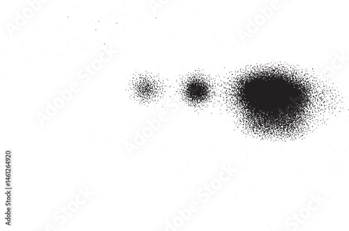 A collection of dark scattered dots rests on a clean white background.