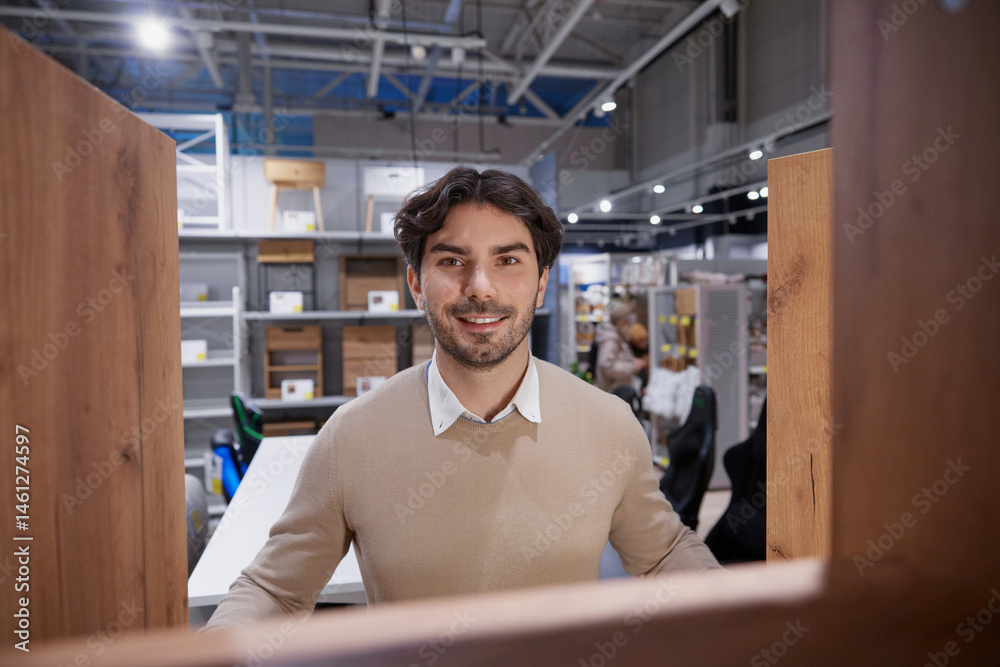 Man stands confidently with bright smile embodying success in modern, contemporary work environment