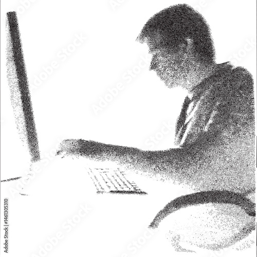 A person intently types on a computer screen in a darkened office.