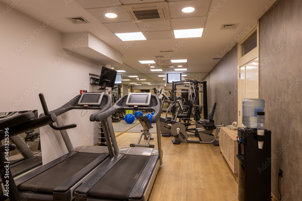 Modern hotel fitness gym with equipment and mirrors Modern hotel fitness gym with equipment and mirrors