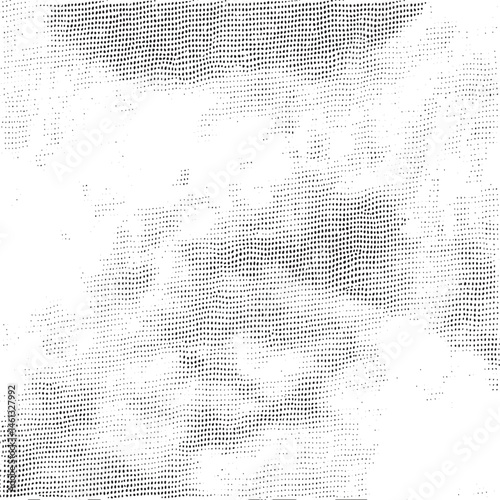 A dense of small white dots covers a smooth light-colored surface.