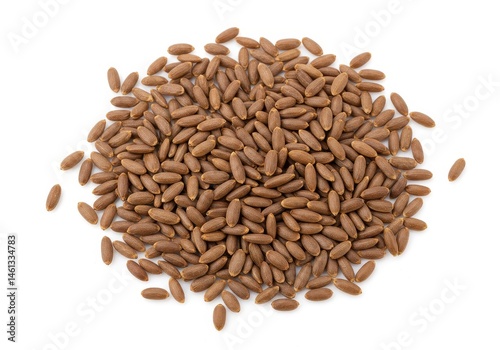 Pile of brown date seeds arranged on a white surface, showing the texture and shape of the natural product