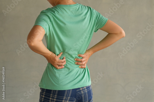 Woman suffering from back pain, have a backache, health problems, human pain concept.