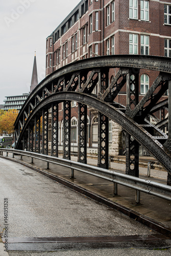 Historic brick buildings and steel bridges over water in Hamburg