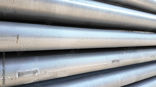 Aluminium round bars in outdoor storage. Pile of aluminum billets logs 