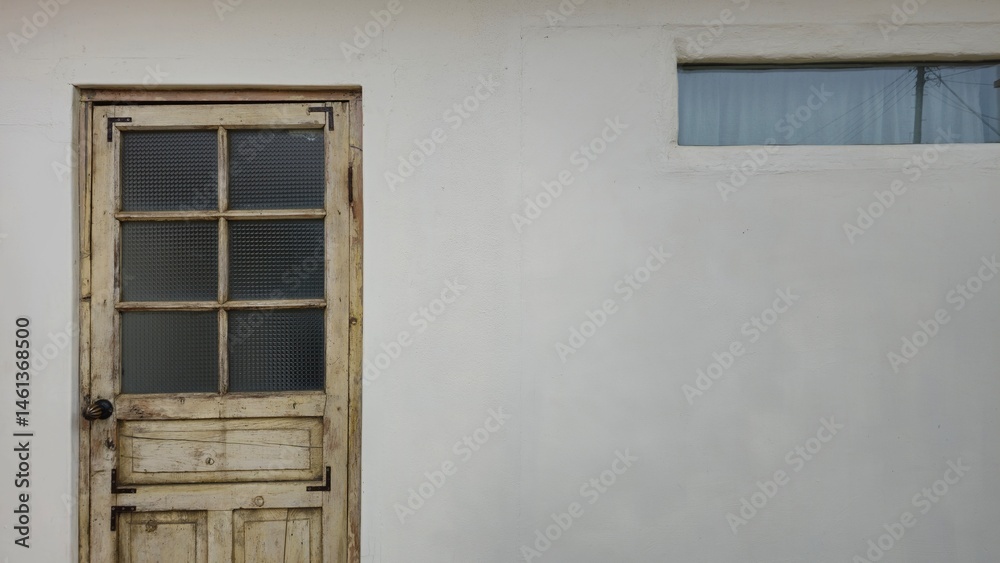 1️⃣ A rustic wooden door with a textured glass pane sits beside a small window on a white wall, offering a charming and nostalgic aesthetic. 1️⃣ A rustic wooden door with a textured glass pane sits beside a small window on a white wall, offering a charming and nostalgic aesthetic.