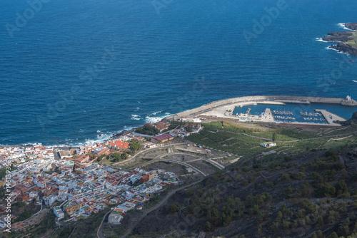 Aerial view of old town Garachico from Mirador de Garachico view point. Colorful houses and harbor. Ocean shore with lava rock pools. Popular tourist destination, Tenerife Canary Islands.