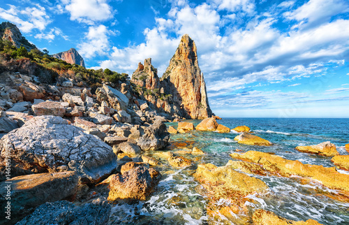 Remarkable view of Punta Pedra Longa and azure water in sea.