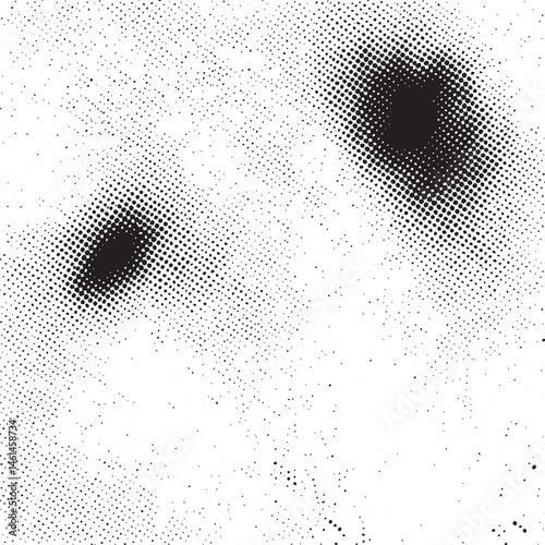 Two dark circles appear against a speckled white background.