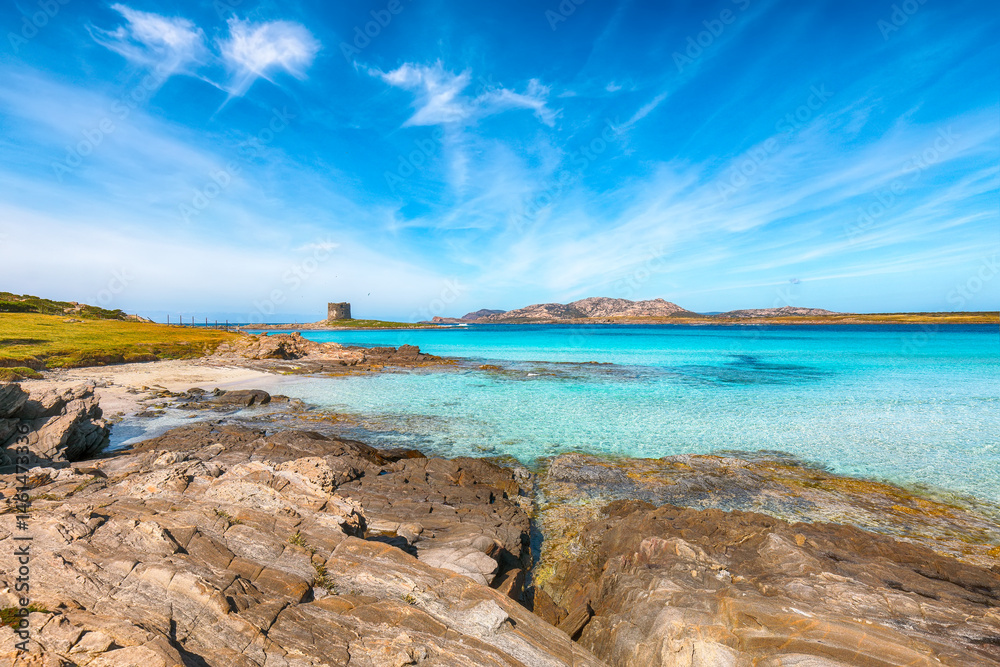 Unbelivable morning view of famous La Pelosa beach and rocky shore near Torre della Pelosa